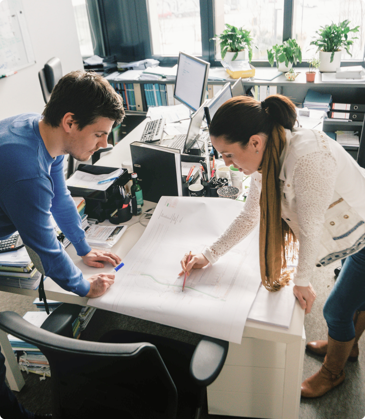 A team of specialists from real estate developer Corwin working in the office on project's documentation