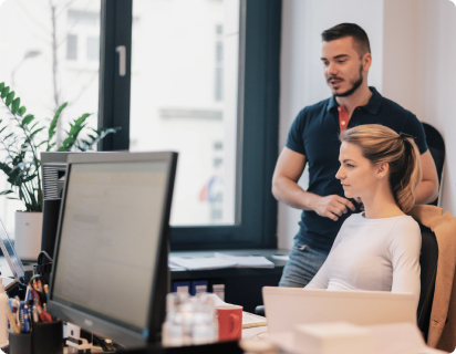 A team of Corwin real estate developer's experts consults an upcoming development project at a computer