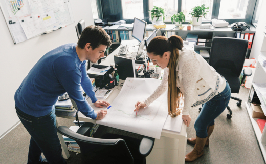 The team of experts of the real estate developer Corwin working in the office on an on-going project